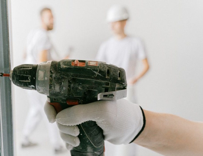 Drilling into drywall on a job site
