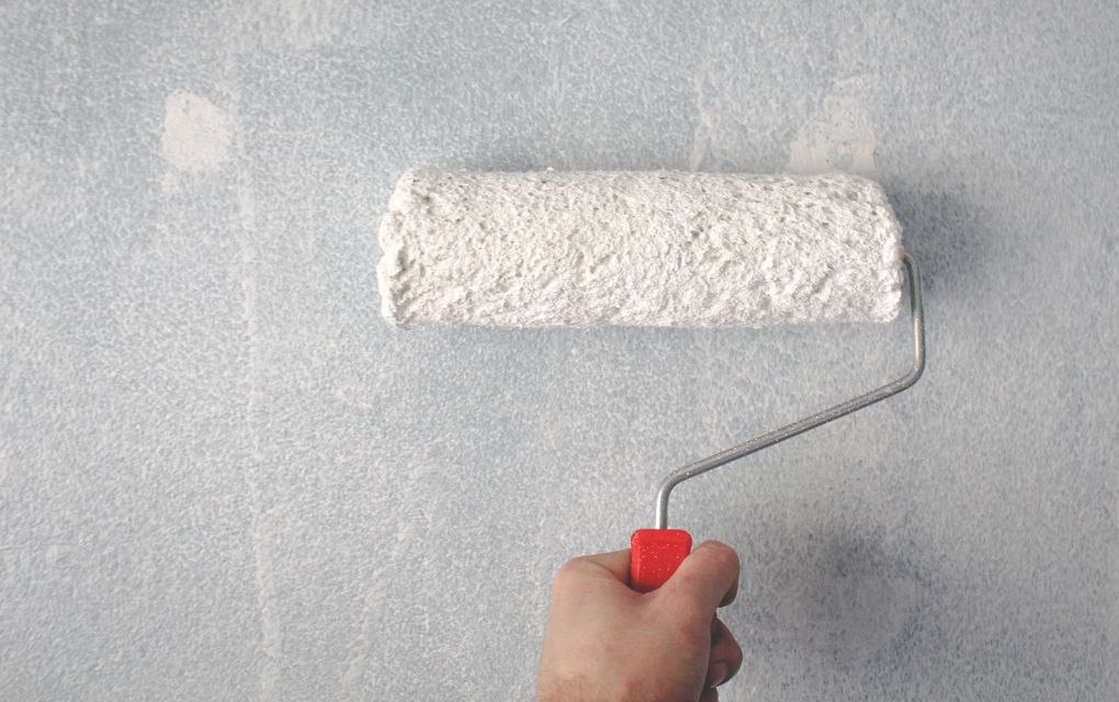 Rolling fresh paint on a wall